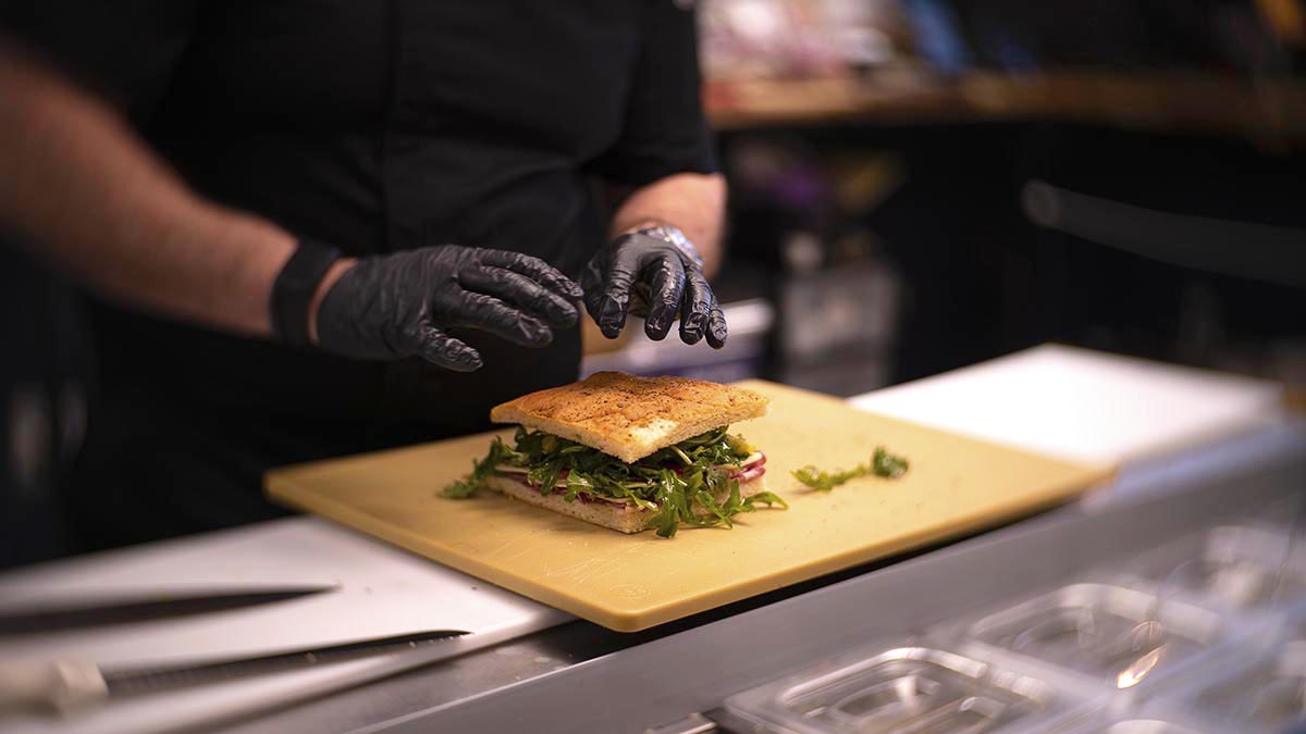 Chef teaching sandwich assembly and display in charcuterie class